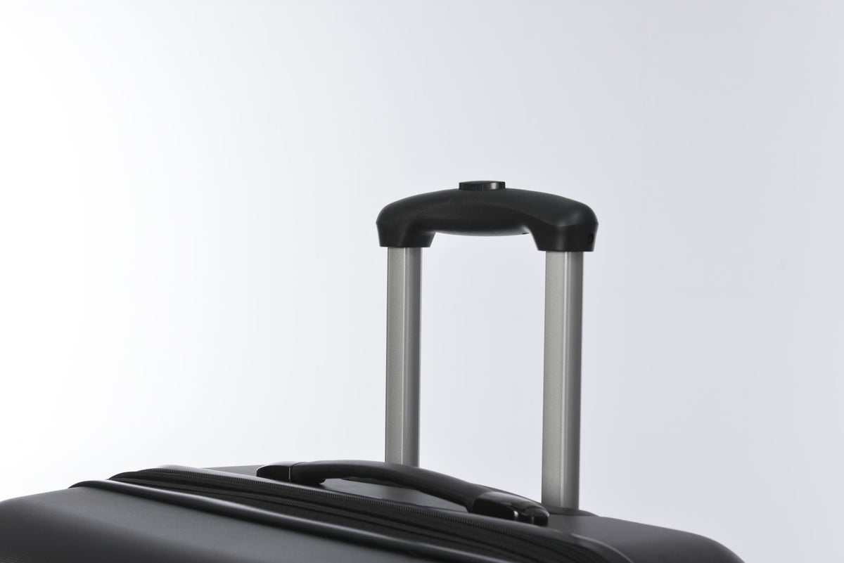 Black hardside spinner suitcase with silver telescoping handle on Tampa Home & Garden Store