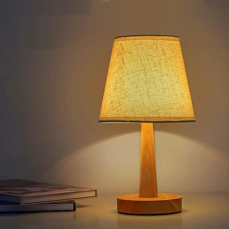 Wooden LED bedside lamp with natural wood stem and beige fabric shade on Tampa Home & Garden Store