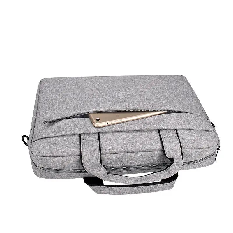 Gray FLIPSTYLEZLLC laptop bag with top zipper pocket and dual handles, smartphone resting on top on Tampa Home & Garden Store