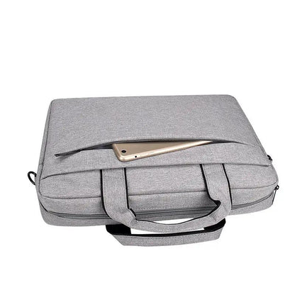 Gray FLIPSTYLEZLLC laptop bag with top zipper pocket and dual handles, smartphone resting on top on Tampa Home & Garden Store