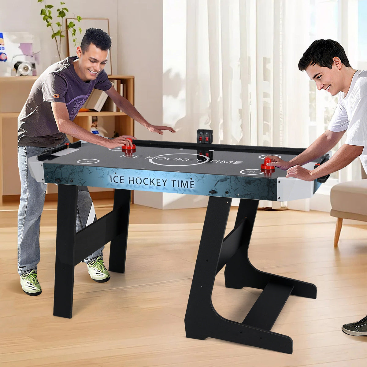 56-inch black air hockey table with LED scoreboard; two players duel on Tampa Home & Garden Store