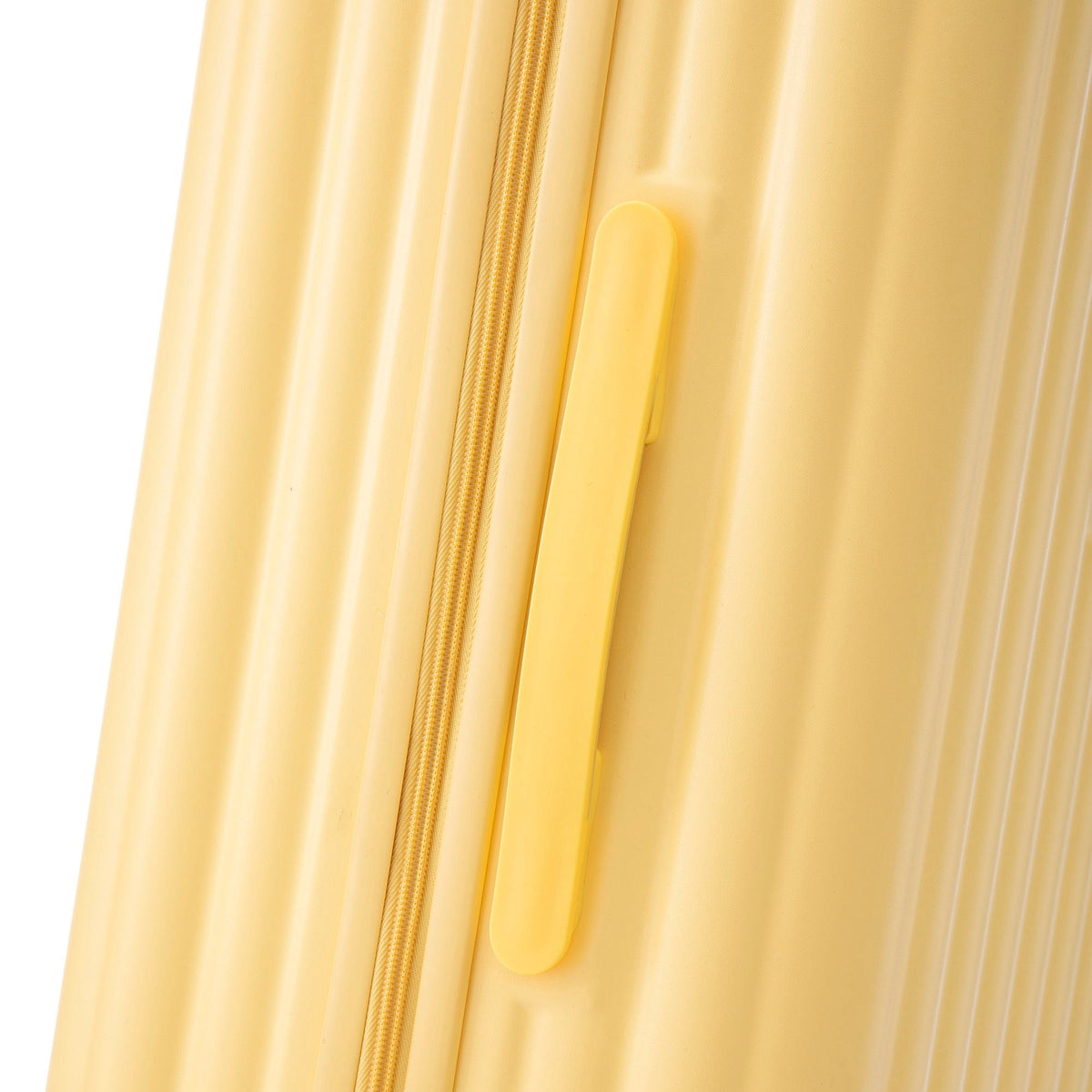 Yellow carry-on luggage zipper and molded handle close-up on Tampa Home & Garden Store