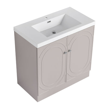 Freestanding bath vanity with white resin sink atop a beige cabinet with arched panel doors on Tampa Home & Garden Store