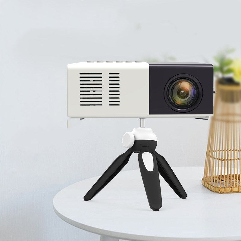 Handheld mini LED projector on a compact tripod; white body with black front on Tampa Home & Garden Store