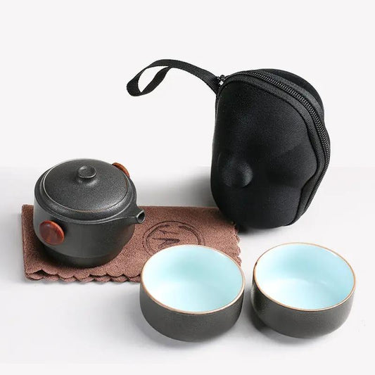 Black pottery tea set for 1–2 with teapot and two blue-inside cups, includes zip pouch on Tampa Home & Garden Store