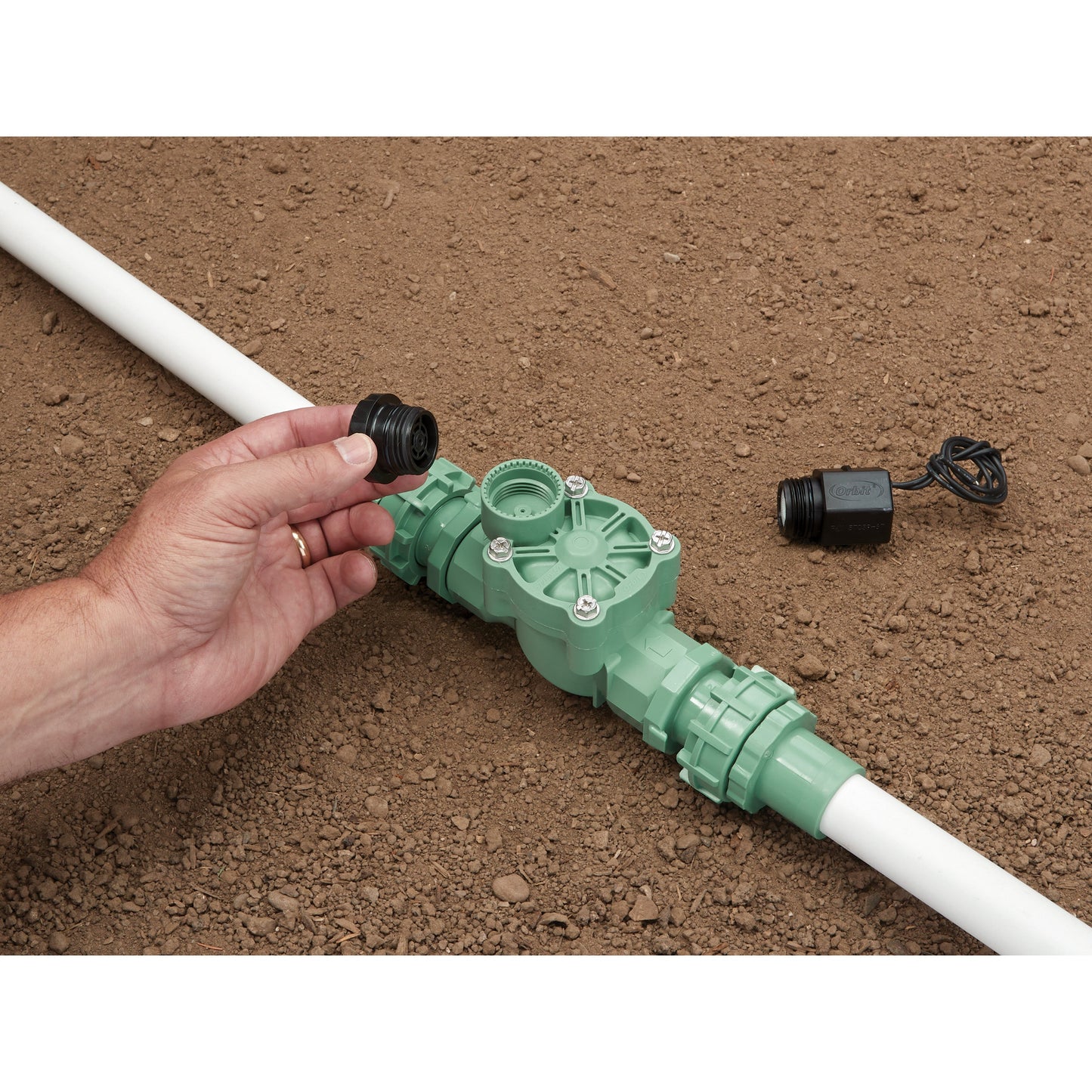 Battery-Powered Sprinkler Controller parts; green valve, white PVC pipe Orbit Irrigation on Tampa Home & Garden Store