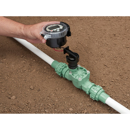 Battery-powered sprinkler controller by Orbit on irrigation line, black timer with clear lid on Tampa Home & Garden Store