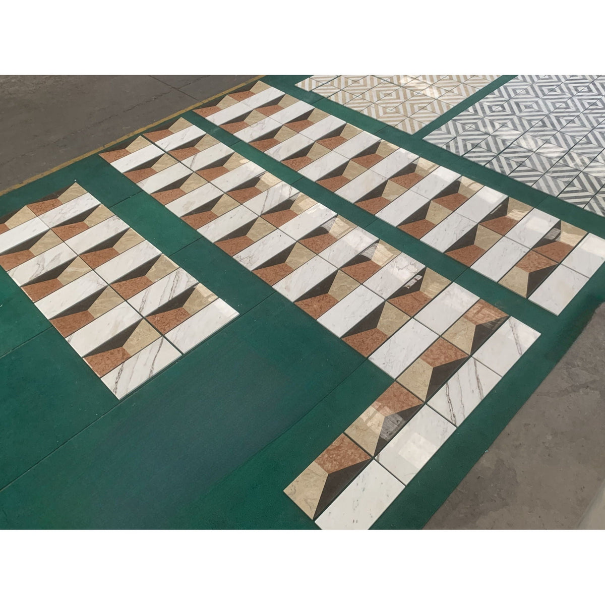 Polished marble decorative tiles with white and multi-tone geometric patterns on a green floor on Tampa Home & Garden Store