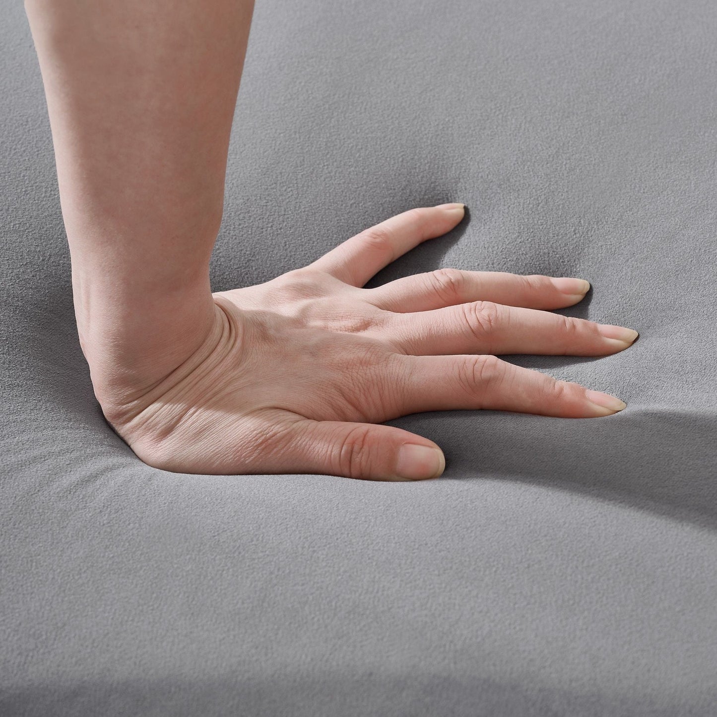 Chesterfield upholstery fabric sofa close-up in gray with hand for scale on Tampa Home & Garden Store
