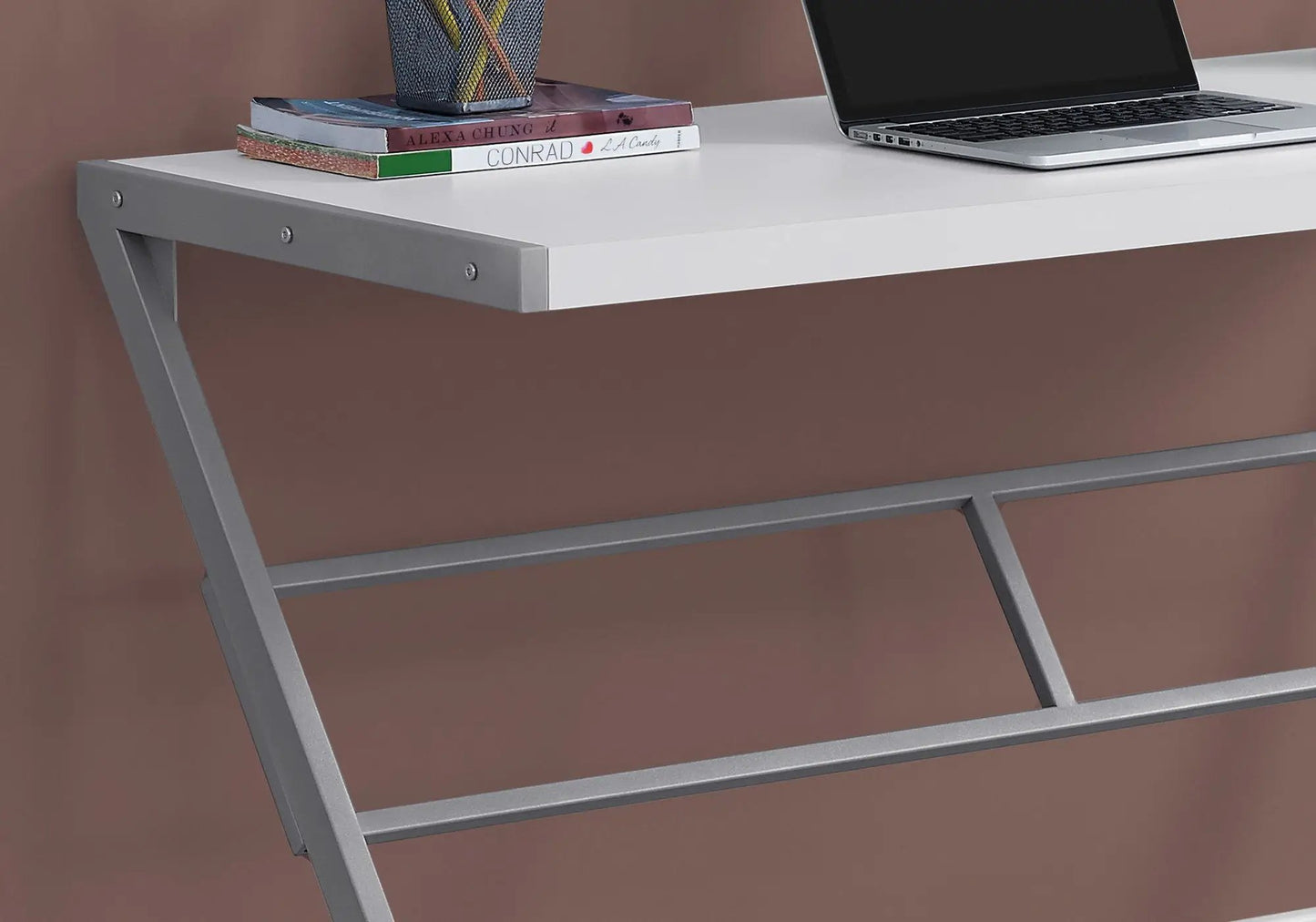 Unique Piece Furniture computer desk, white desktop with gray metal X-frame legs, laptop and books on Tampa Home & Garden Store