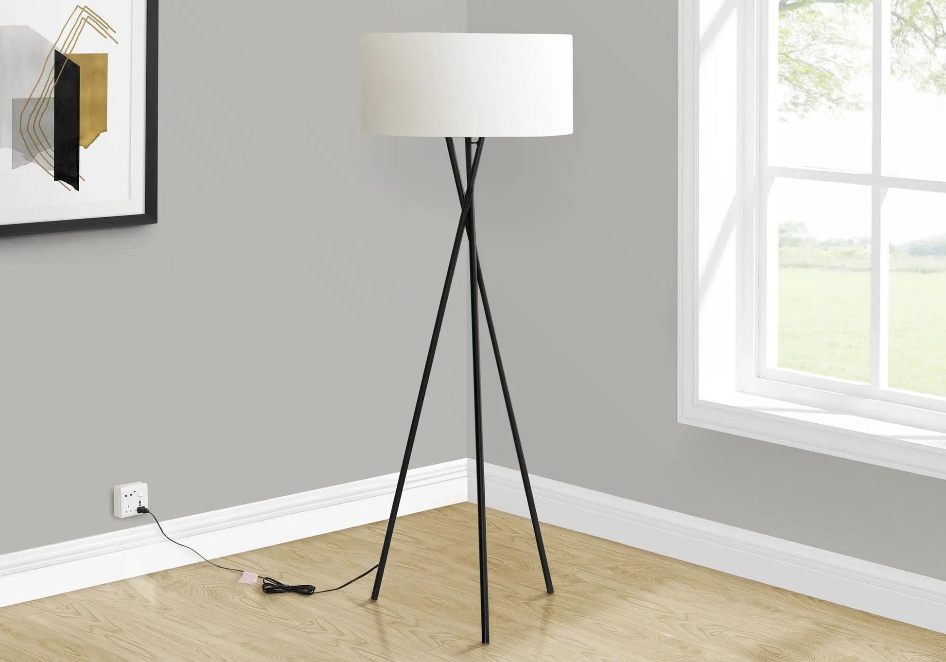 Floor lamp black metal tripod with white drum shade in a modern room on Tampa Home & Garden Store