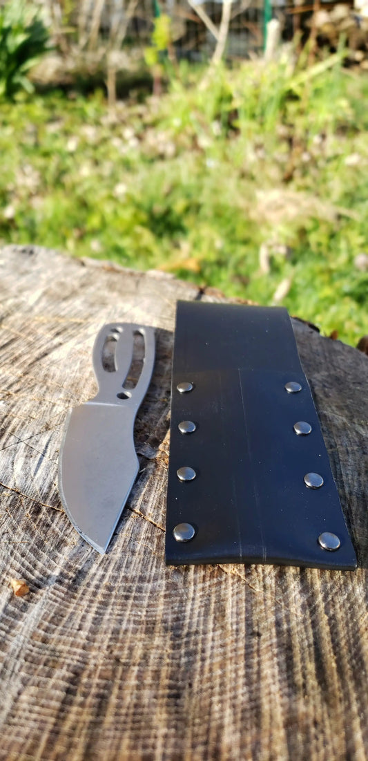 The Grimalkin bushcraft knife with gray blade and cutout handle, black riveted sheath on Tampa Home & Garden Store