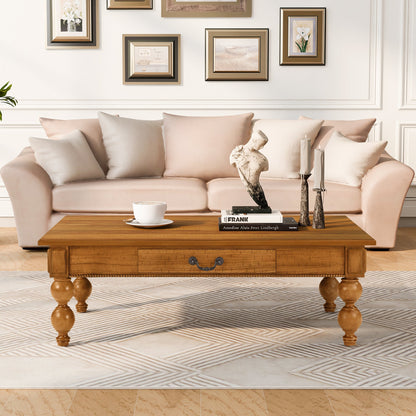 Rectangular oak coffee table with storage drawer and turned legs blush sofa and books on Tampa Home & Garden Store