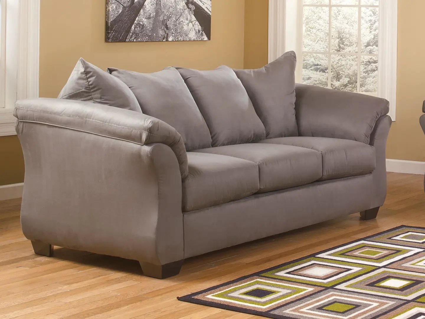 Darcy sofa gray fabric upholstery with plush back cushions and curved arms in a sunlit living room on Tampa Home & Garden Store