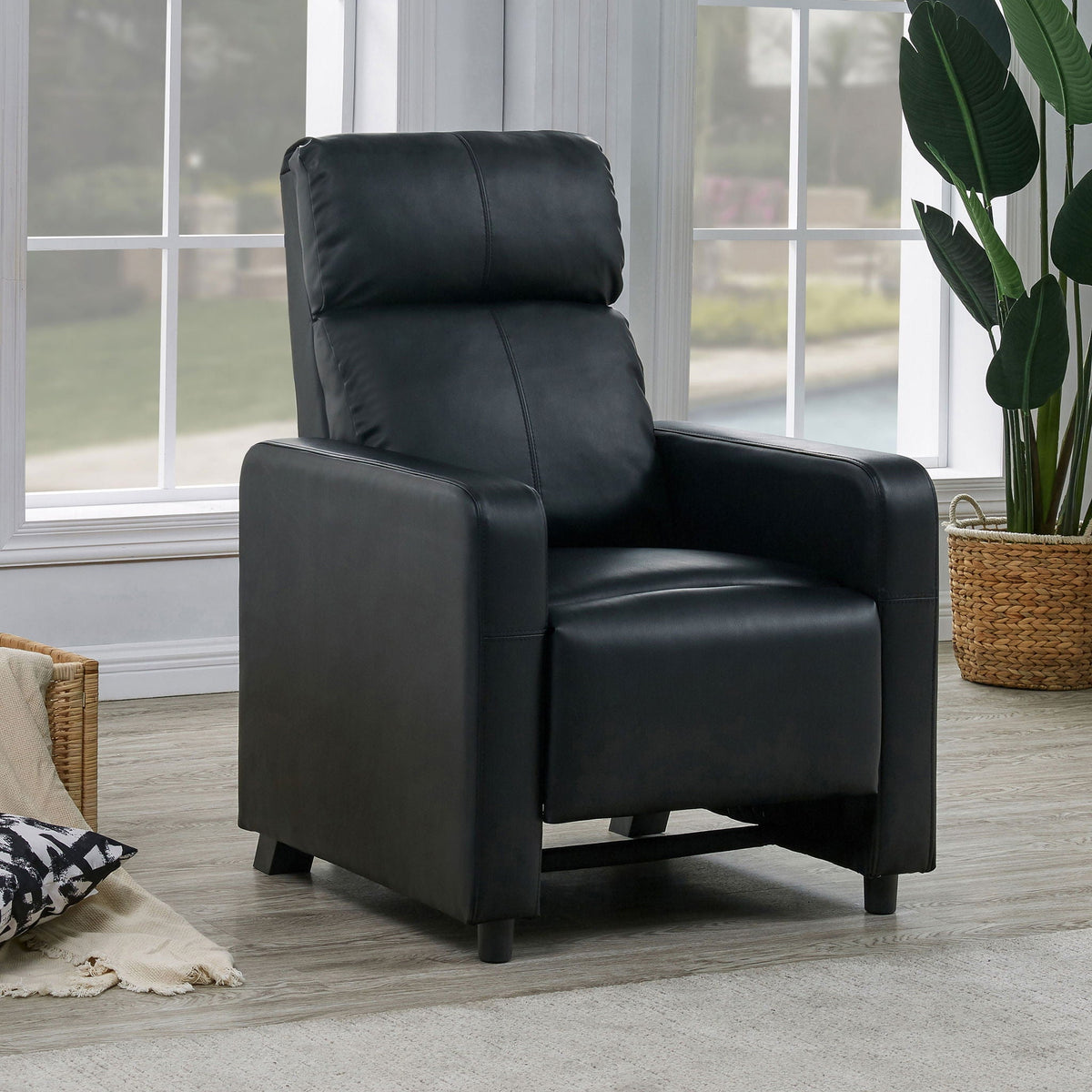 Push Back Recliner Black leather recliner chair in a bright windowed living space on Tampa Home & Garden Store