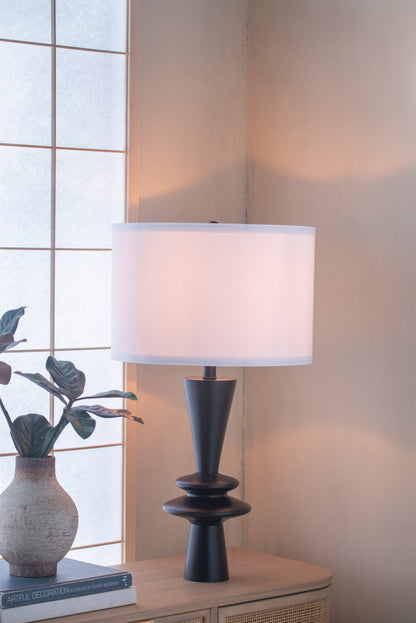 D15x26.7 Table Lamp by HouseOfZazla with black tapered base and white drum shade on a light wood table beside a potted plant on Tampa Home & Garden Store