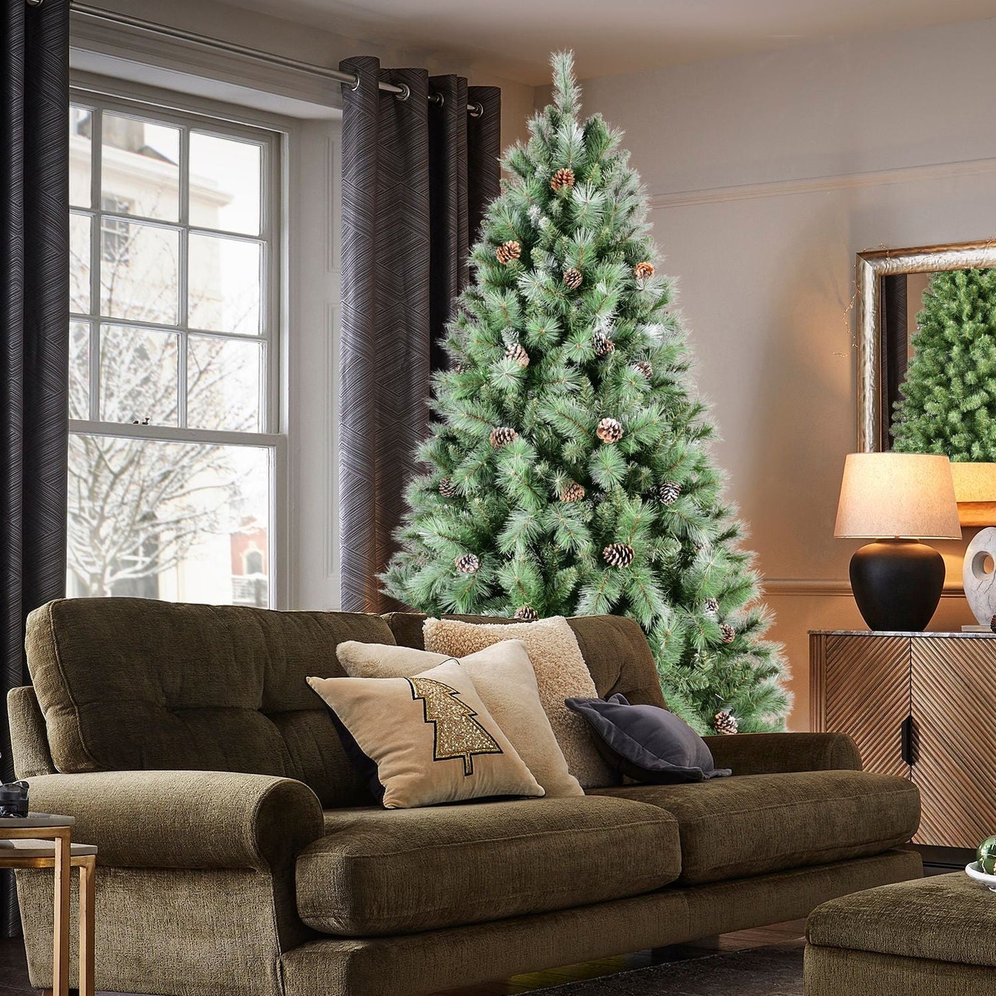 8 ft lush green pre-decorated pinecone Christmas tree with pinecone accents in a living room on Tampa Home & Garden Store