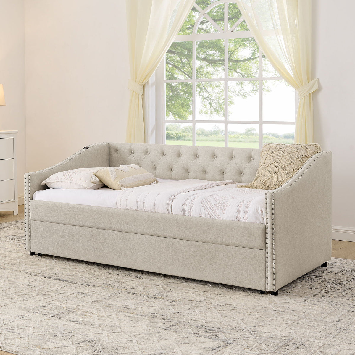 Beige upholstered daybed with tufted back and nailhead trim, simple bedroom display on Tampa Home & Garden Store