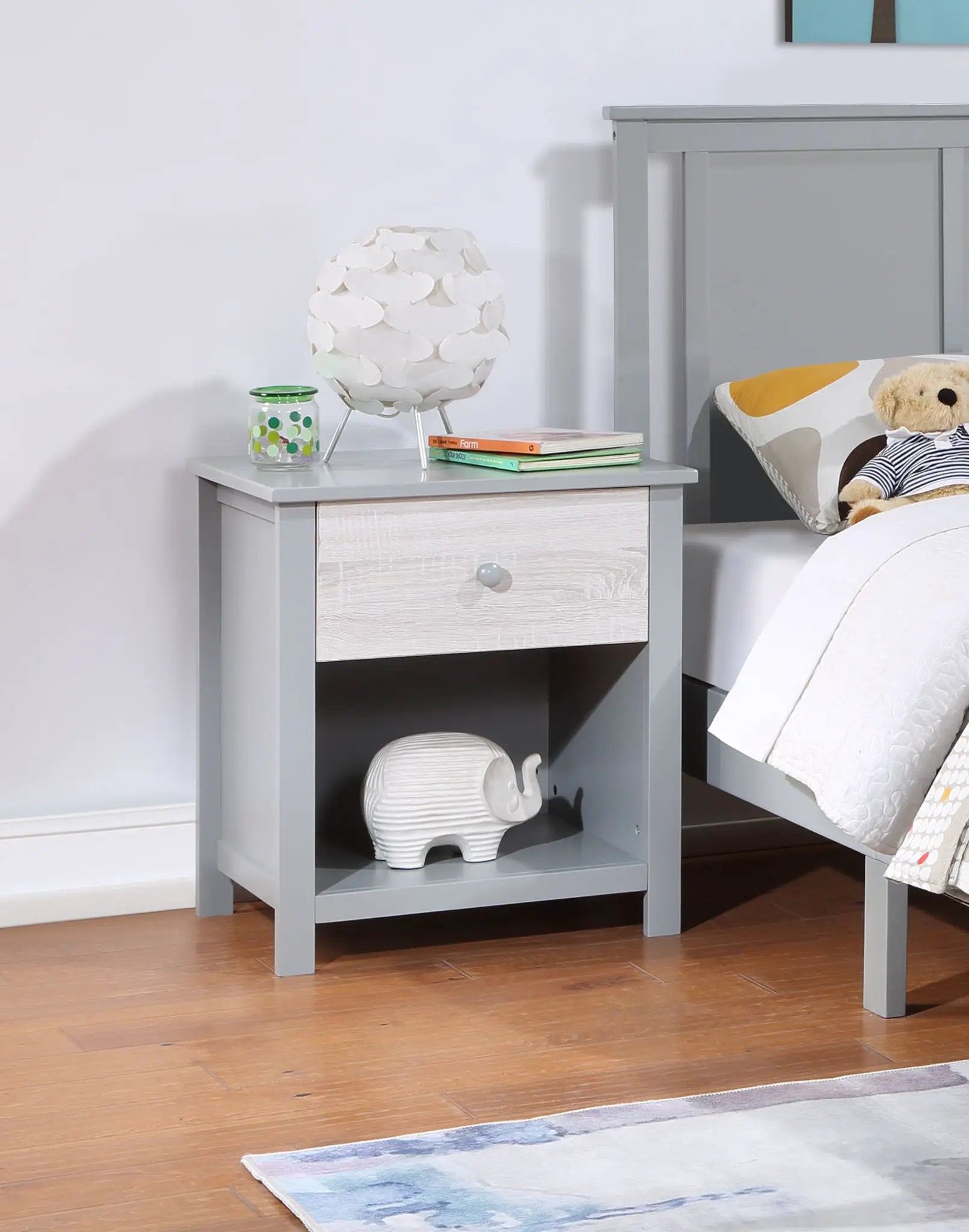 Connelly nightstand, gray-blue wood finish with drawer and shelf, topped by a white petal lamp on Tampa Home & Garden Store