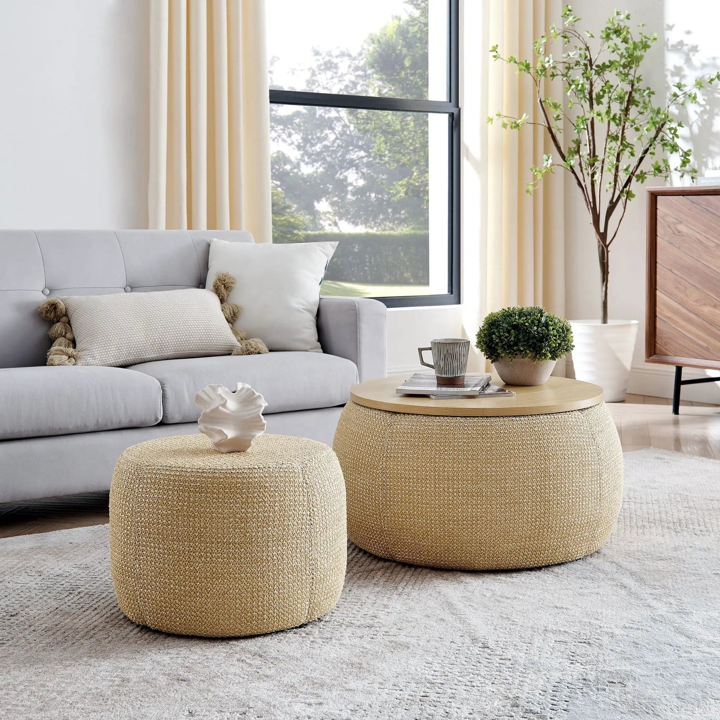 Round woven storage ottomans, two natural stools beside a gray sofa in a living room on Tampa Home & Garden Store