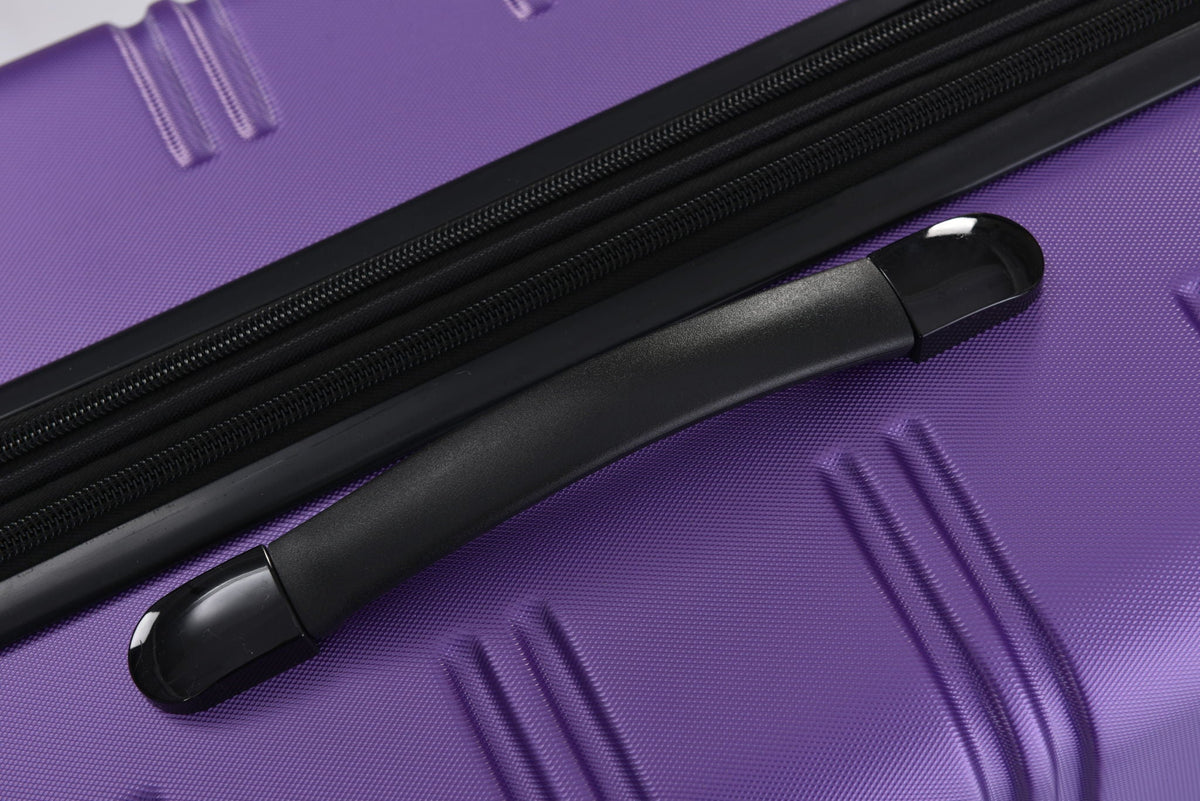 Hardshell luggage close-up in purple with black zipper tracks and molded handle on Tampa Home & Garden Store