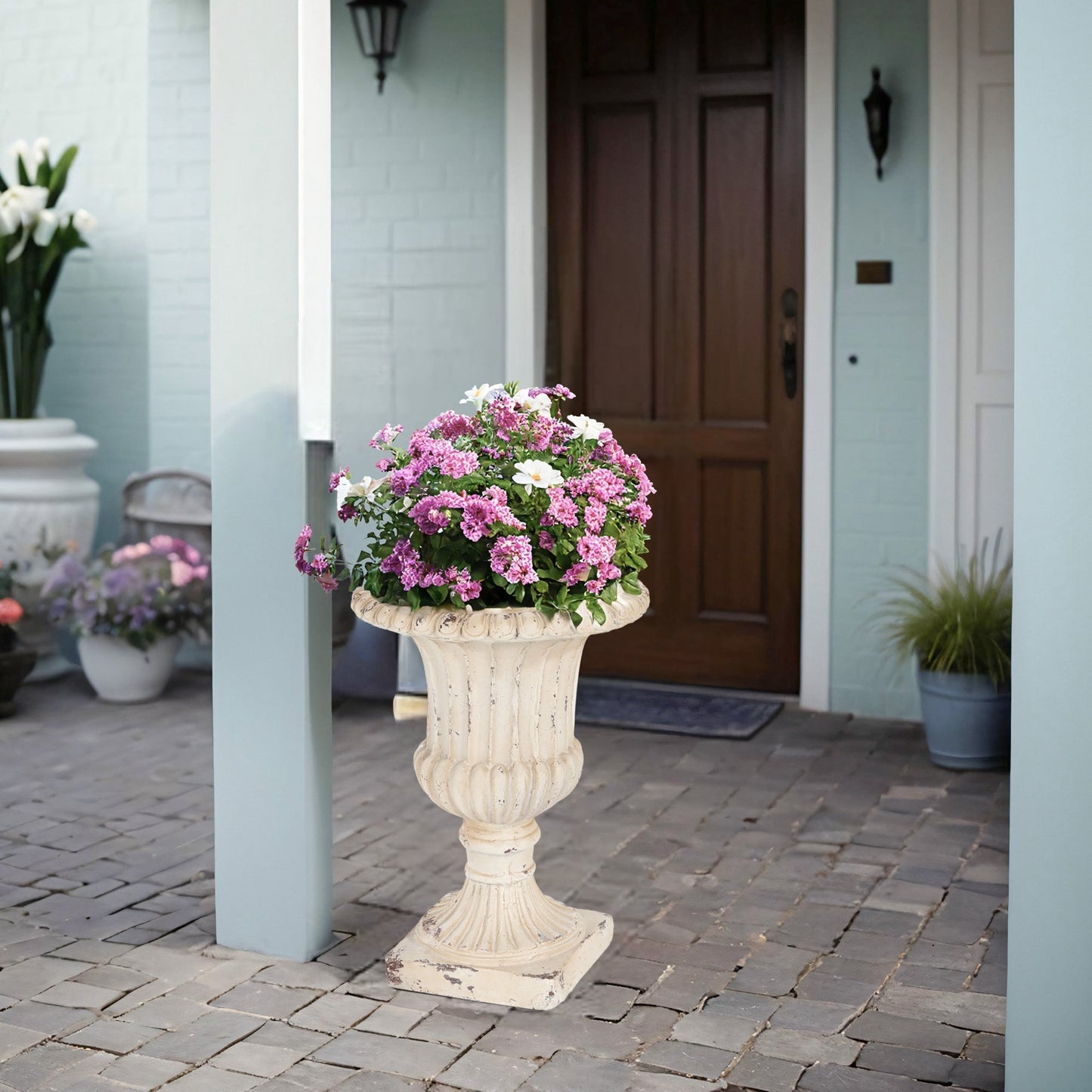 MGO Garden Urn antique white planter on carved pedestal with pink and white flowers on Tampa Home & Garden Store