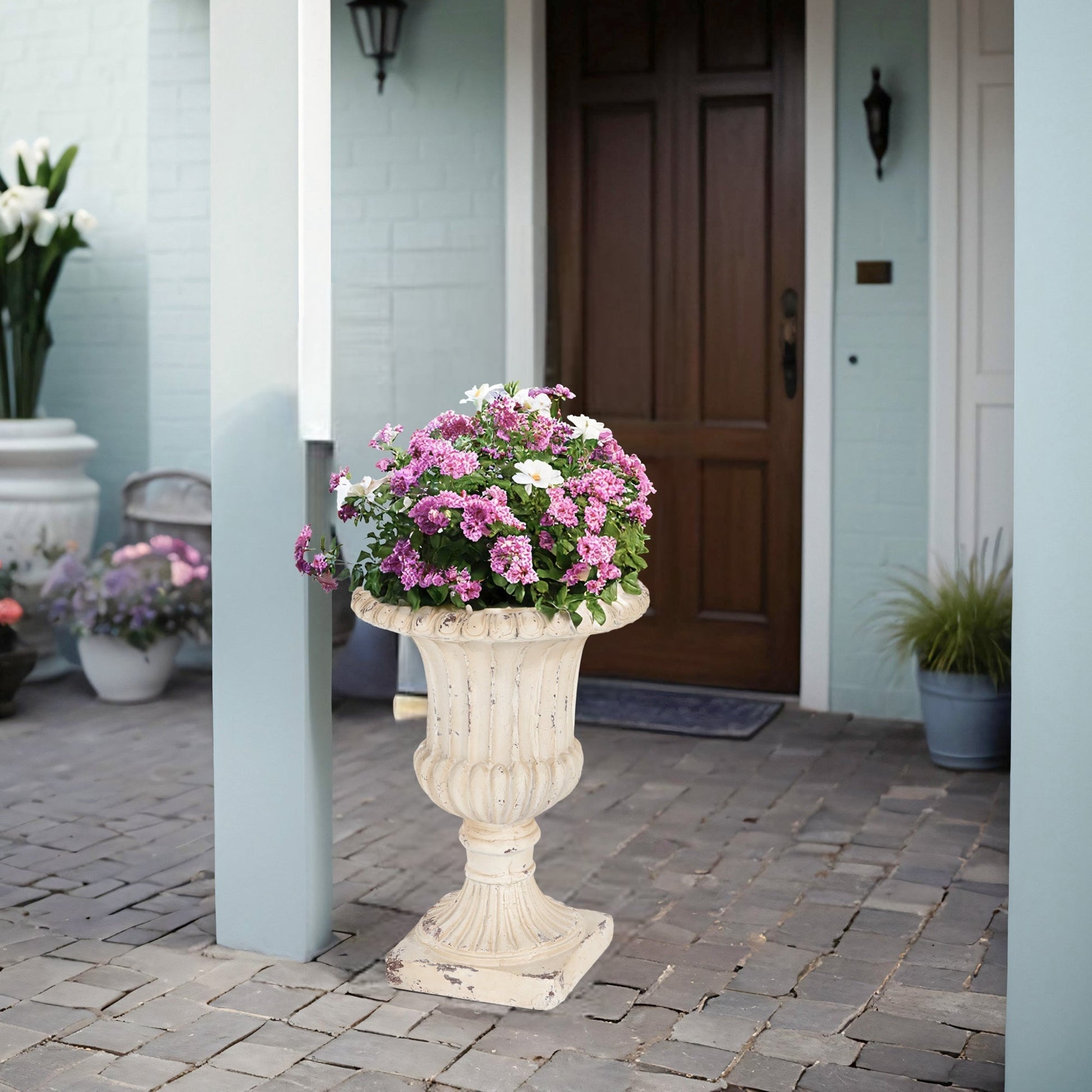 MGO Garden Urn antique white planter on carved pedestal with pink and white flowers on Tampa Home & Garden Store
