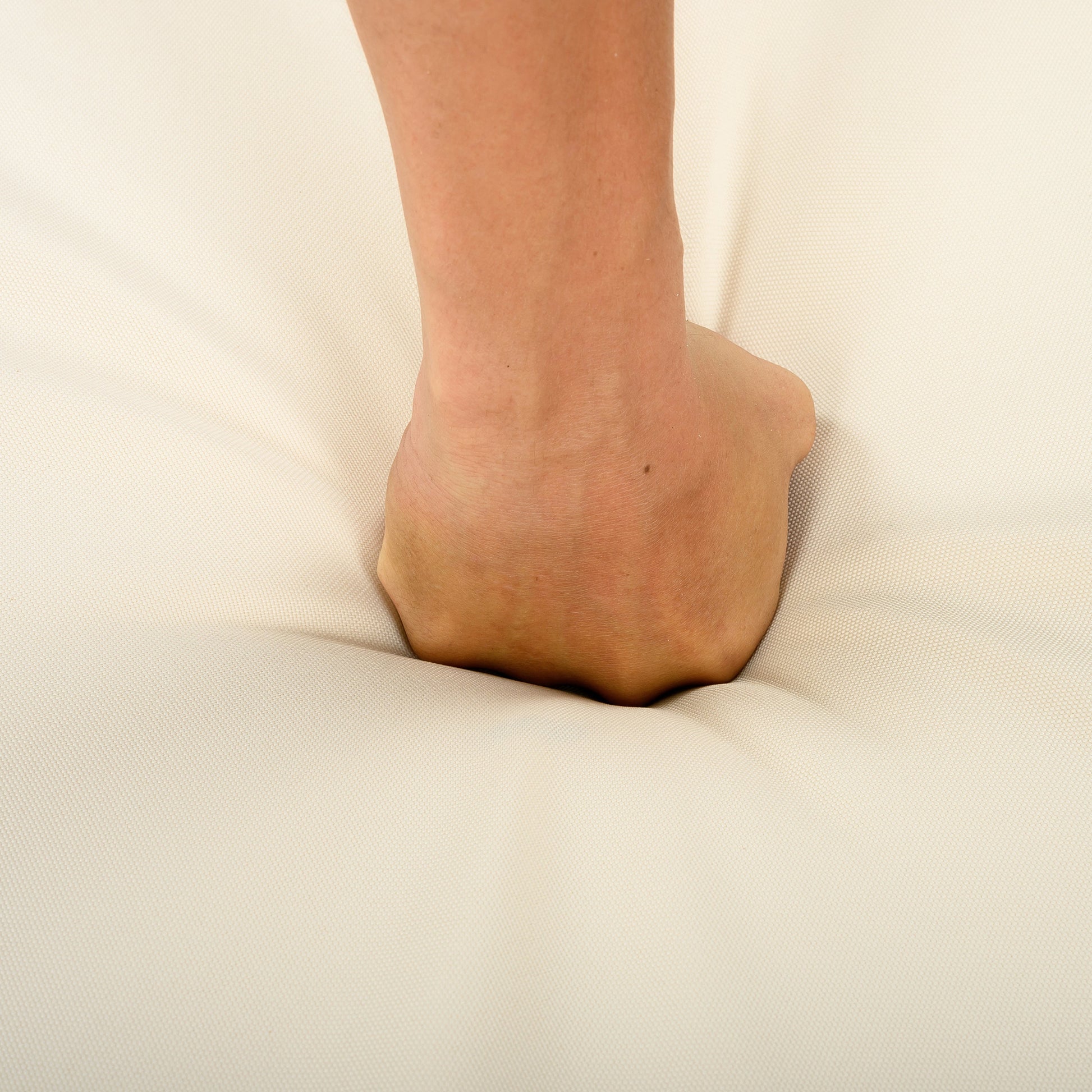Close-up of a bare neck and shoulder against beige fabric backdrop on Tampa Home & Garden Store