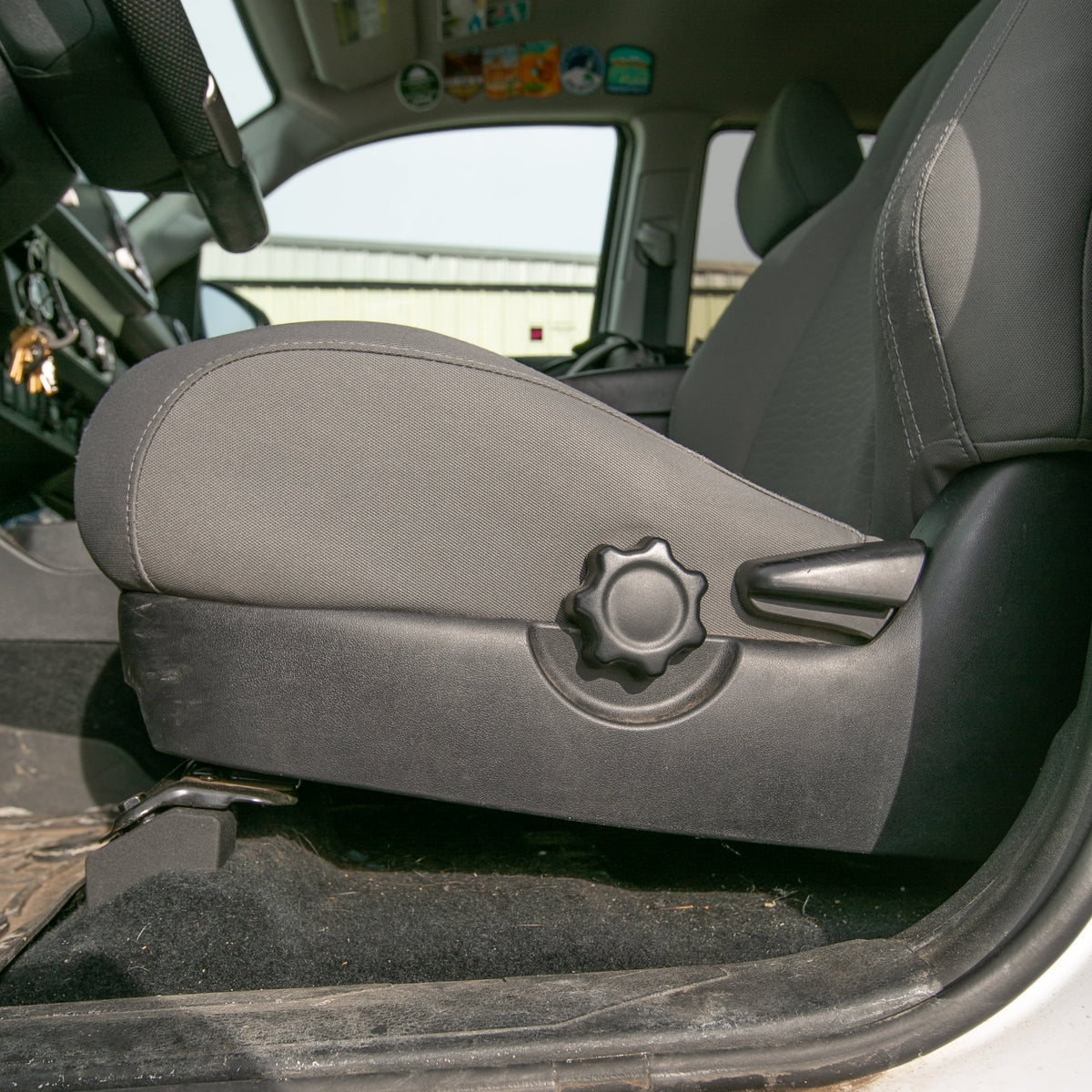 Front Seat Riser for Toyota & Lexus black knob with grey fabric seat in cabin on Tampa Store on Tampa Home & Garden Store
