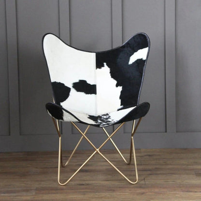 The Holsteins Butterfly Chair with cowhide print seat and gold-tone metal legs on Tampa Home & Garden Store