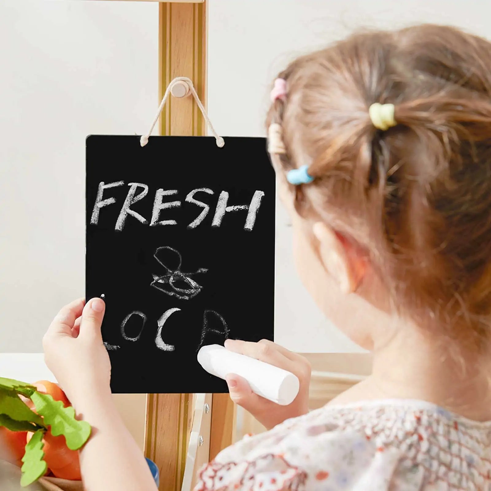 Tiny Land Kid's Grocery Store Playset chalkboard sign on wood stand, child chalk drawing near produce on Tampa Home & Garden Store