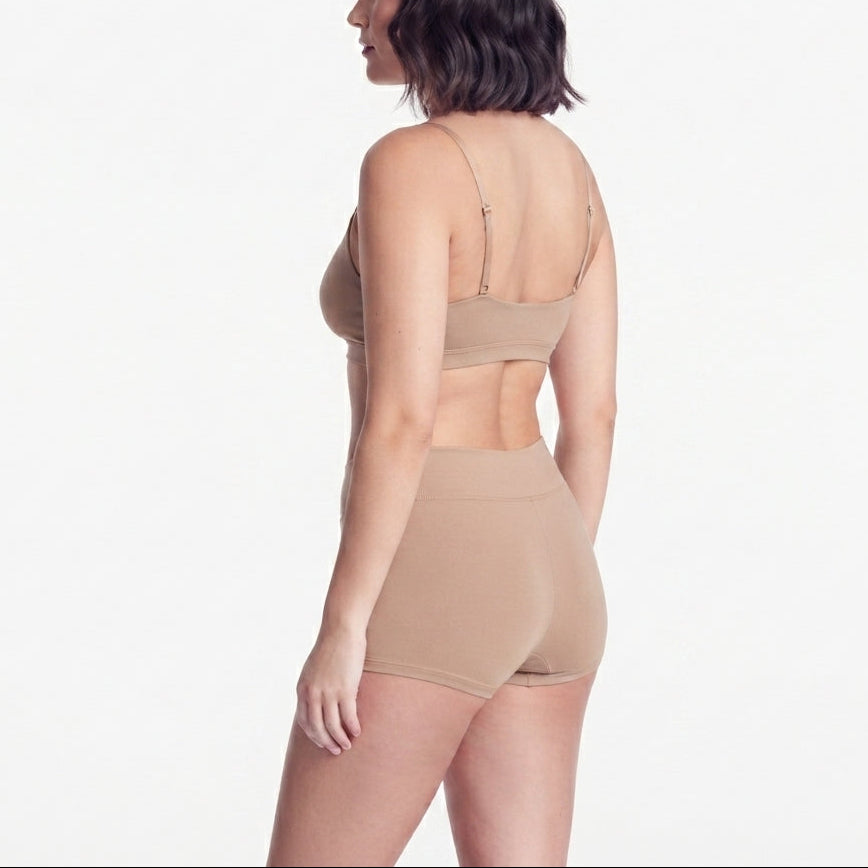 Boyshorts organic cotton beige on model, Net Positive brand, back view on Tampa Home & Garden Store
