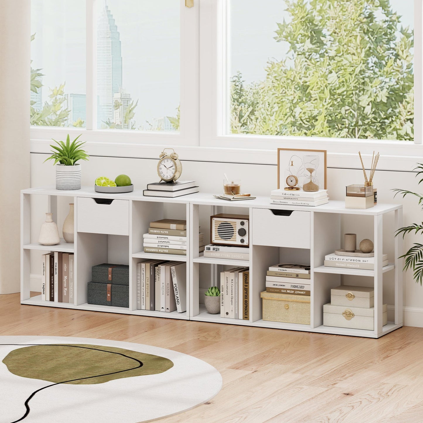White 5-cube bookcase with storage drawers, topped with plant and clock in a bright living room on Tampa Home & Garden Store