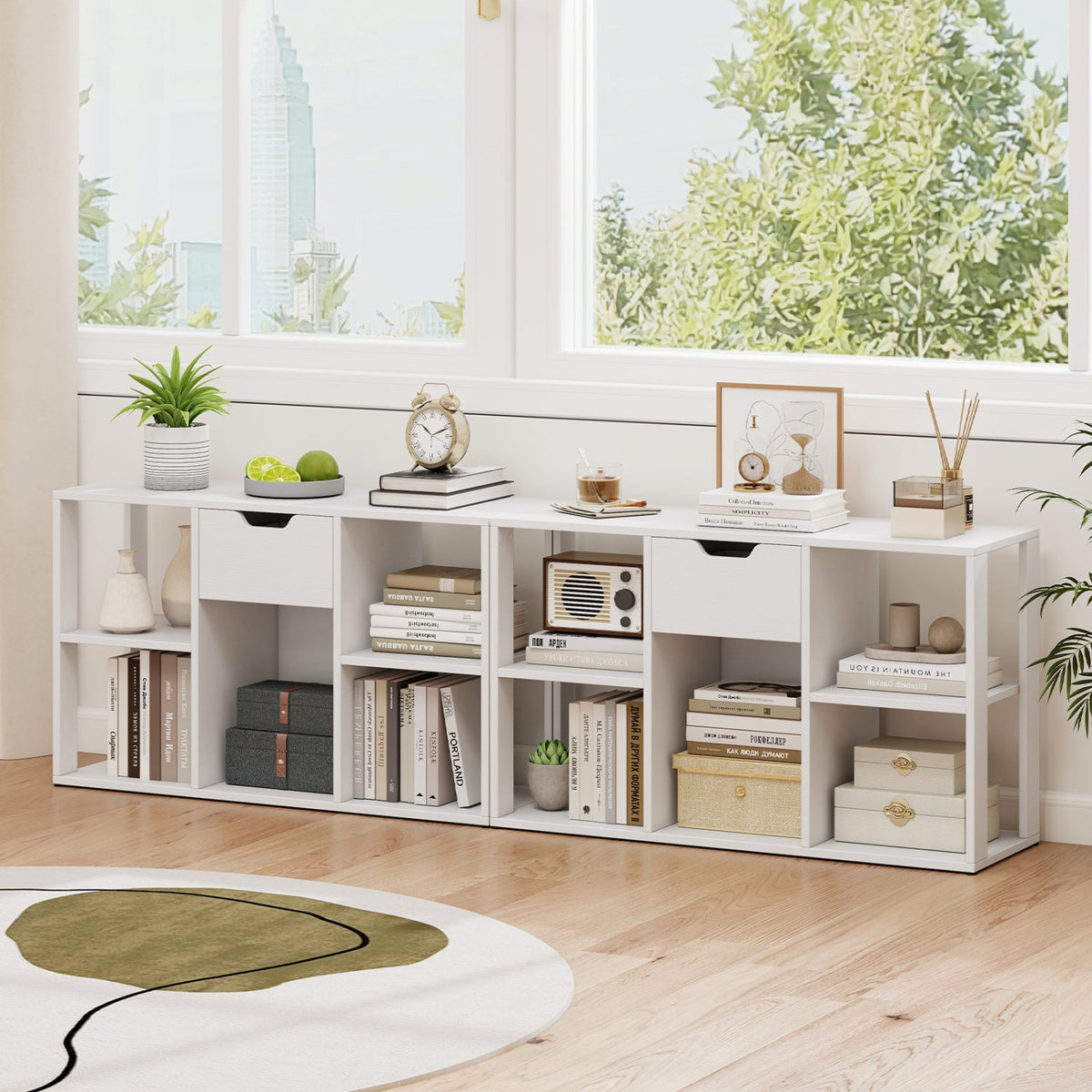 White 5-cube bookcase with storage drawers, topped with plant and clock in a bright living room on Tampa Home & Garden Store