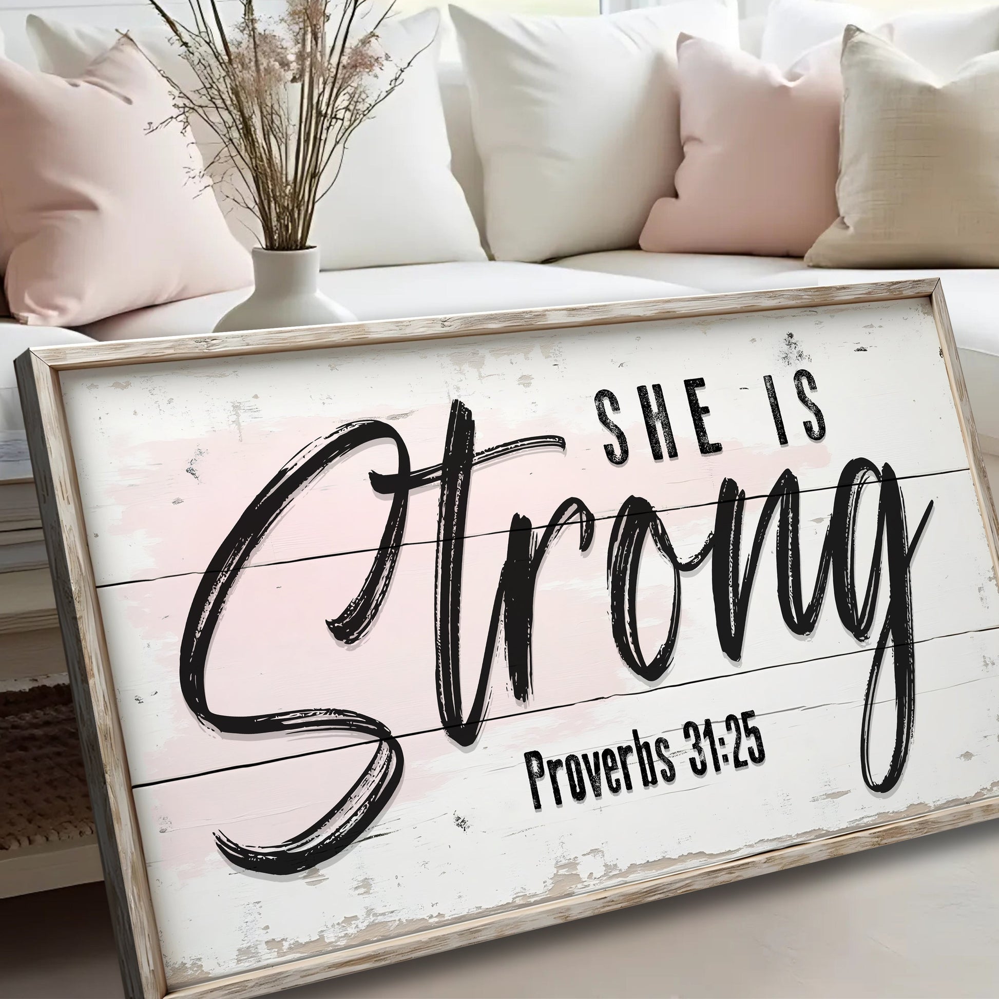 Canvas sign She Is Strong Proverbs 31:25 Faith Sign with frame and pink backdrop beside vase on Tampa Home & Garden Store