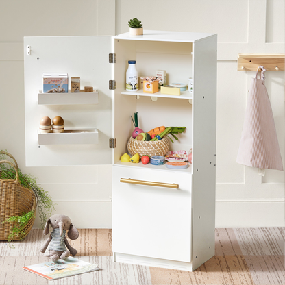Tiny Land Organic Meat & Seafood Pack play food set in a white cabinet with milk and eggs on Tampa Home & Garden Store