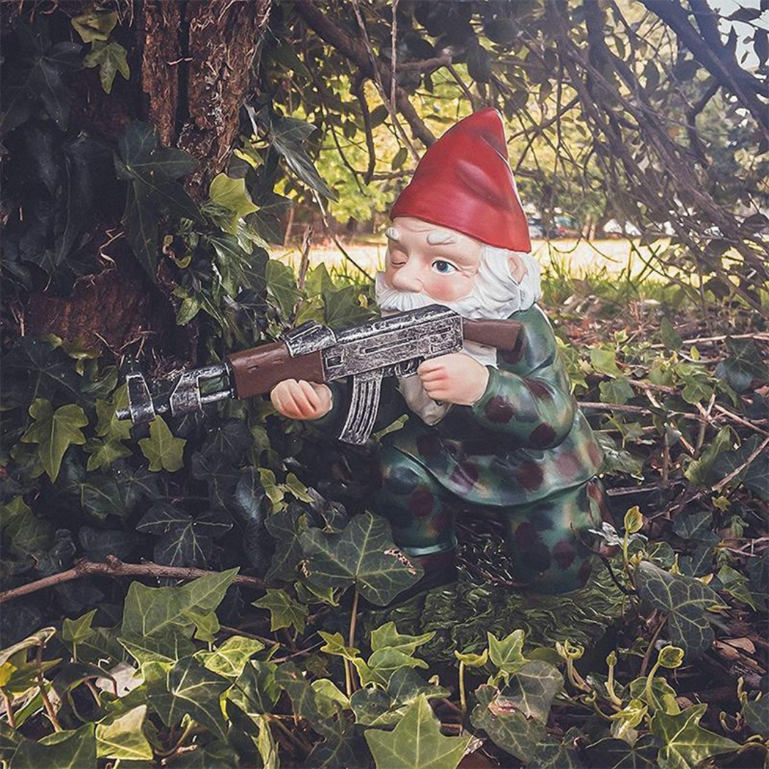 Military garden gnome statue in camouflage with red hat, holding a rifle garden sculpture on Tampa Home & Garden Store
