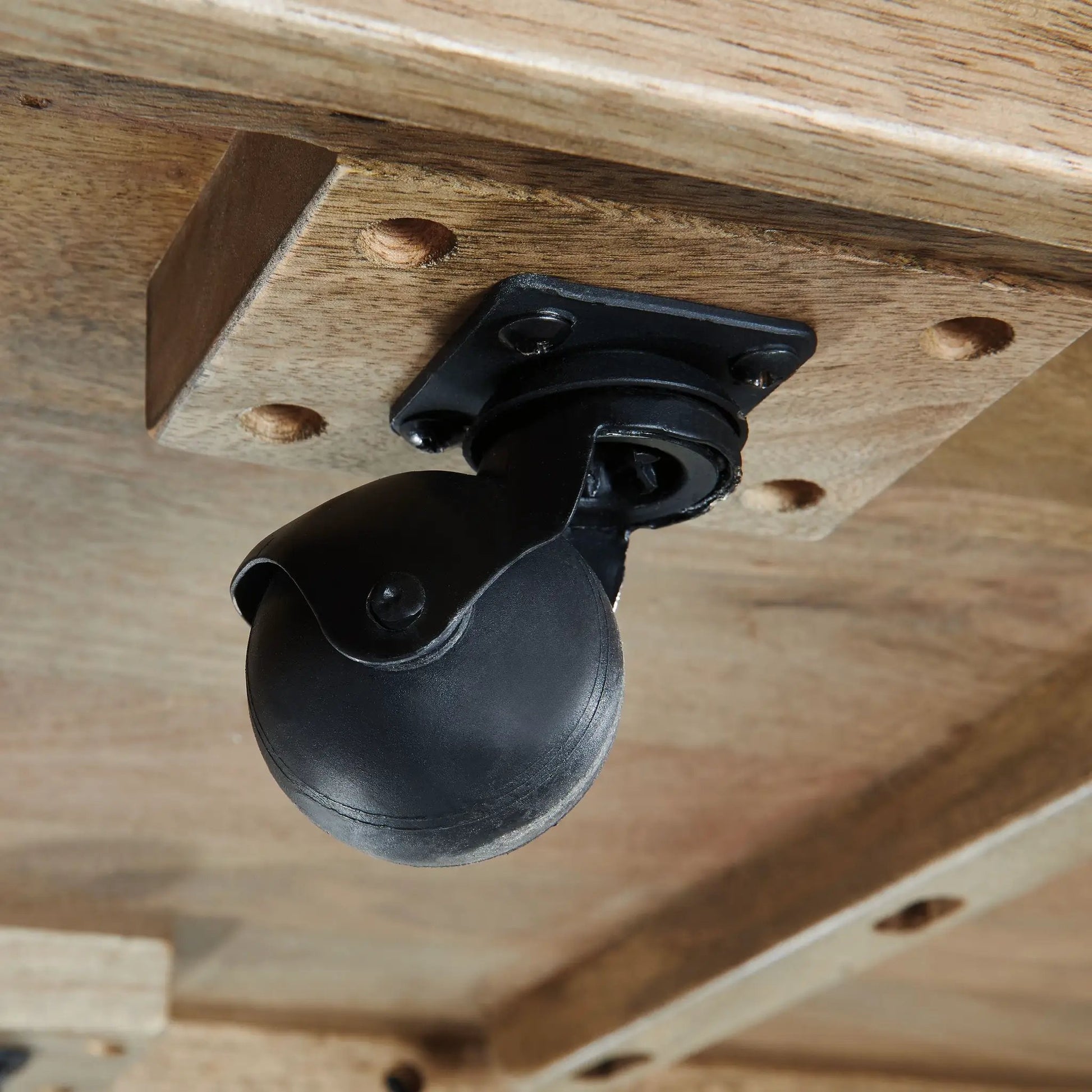 Brendalhouse Rectangular Table underside with black caster wheel mounting on wood planks on Tampa Home & Garden Store