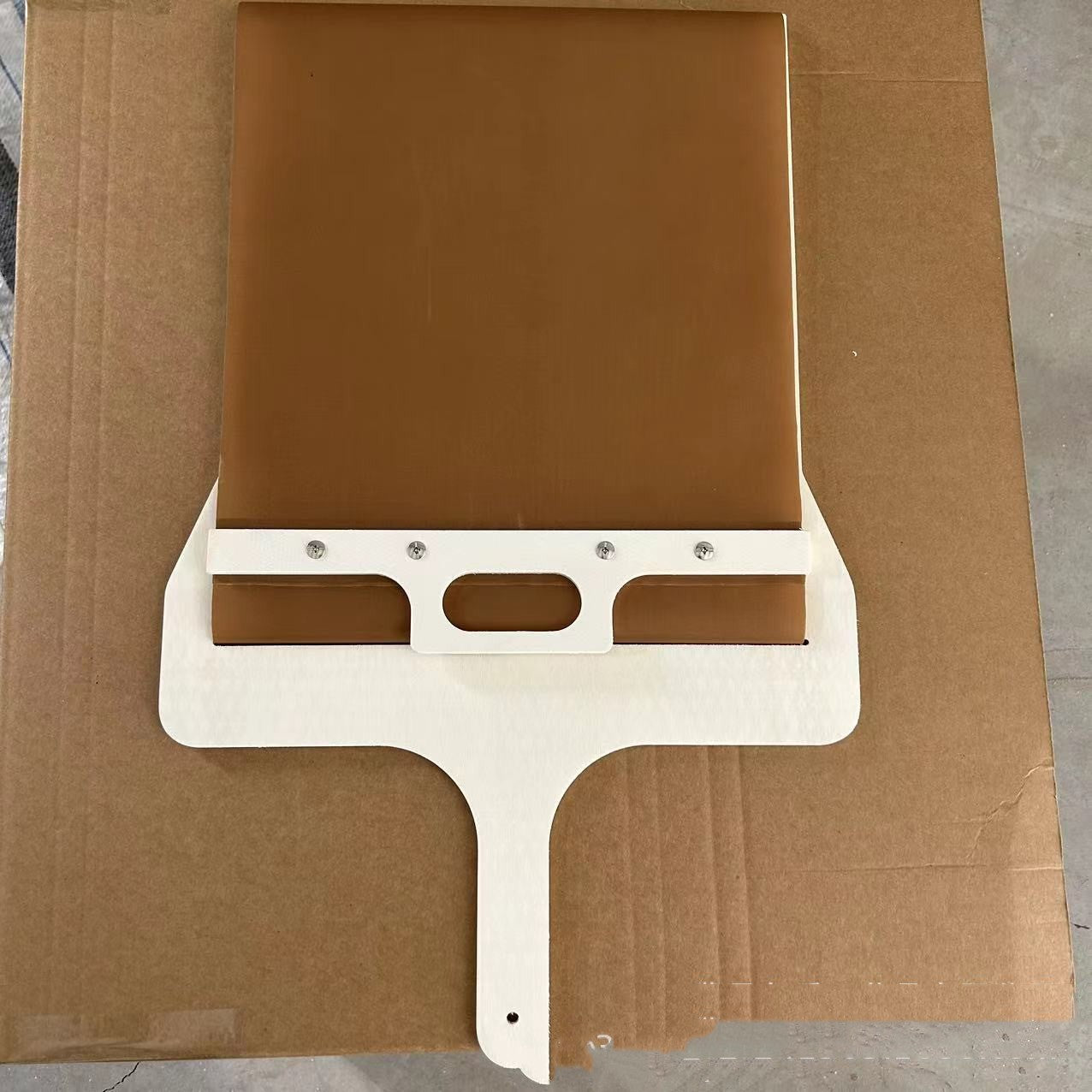 Perfecsy sliding pizza peel with brown wooden panel and white metal frame on Tampa Home & Garden Store