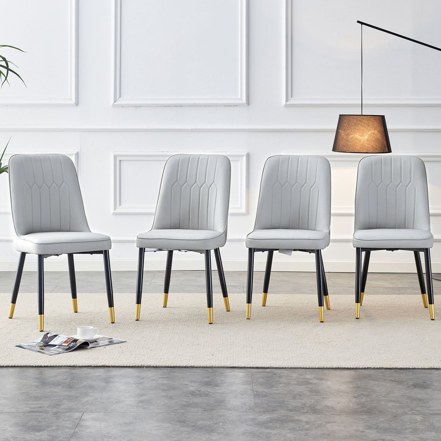 Modern gray upholstered chairs with black metal legs and gold-tipped feet, six in a row on Tampa Home & Garden Store