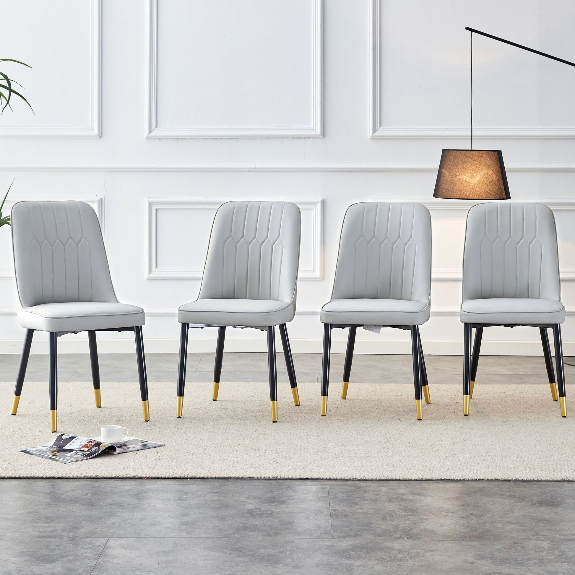 Modern gray upholstered chairs with black metal legs and gold-tipped feet, six in a row on Tampa Home & Garden Store