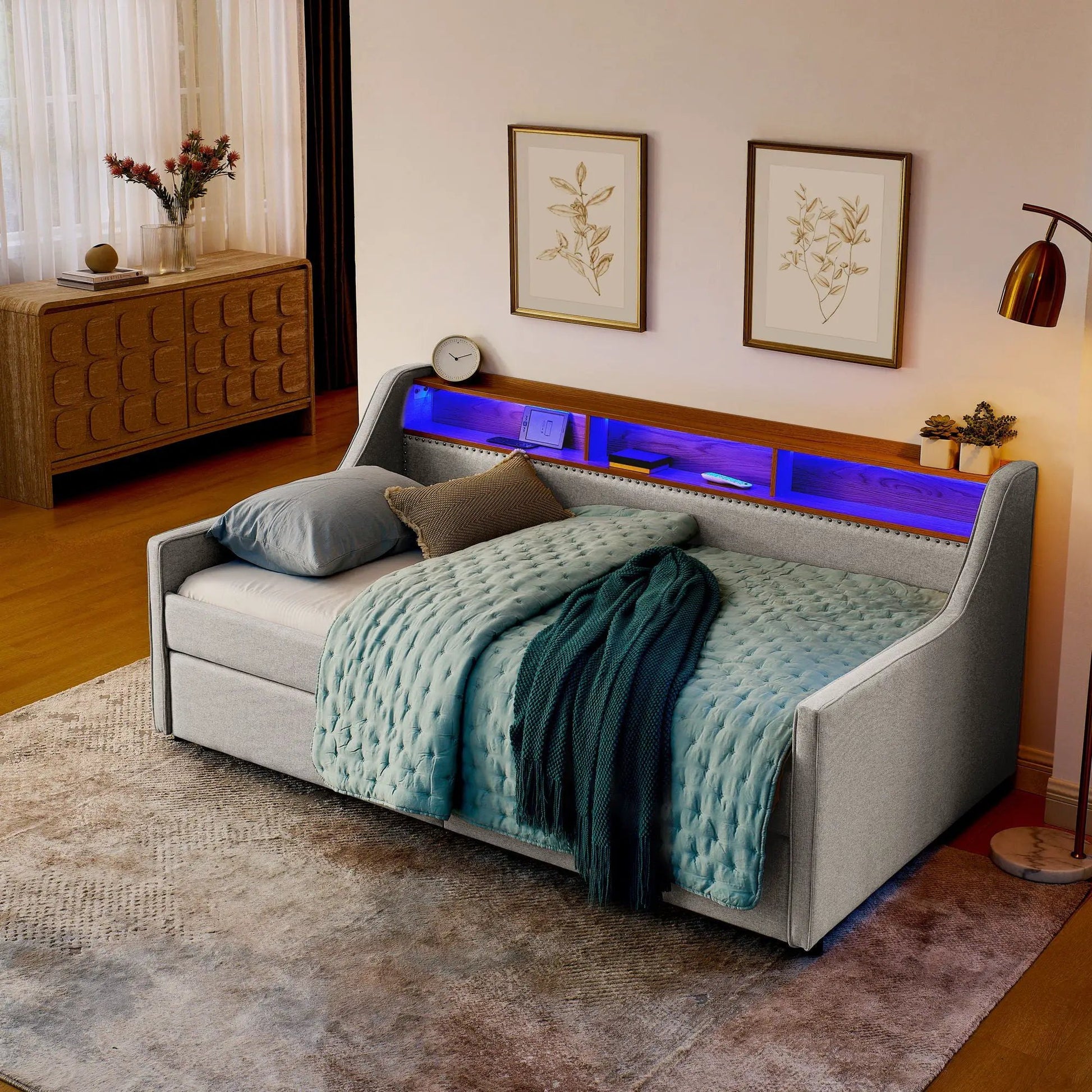 Twin gray upholstered sofa bed with tufted cushions and blue quilted bedding, LED lighting on Tampa Home & Garden Store