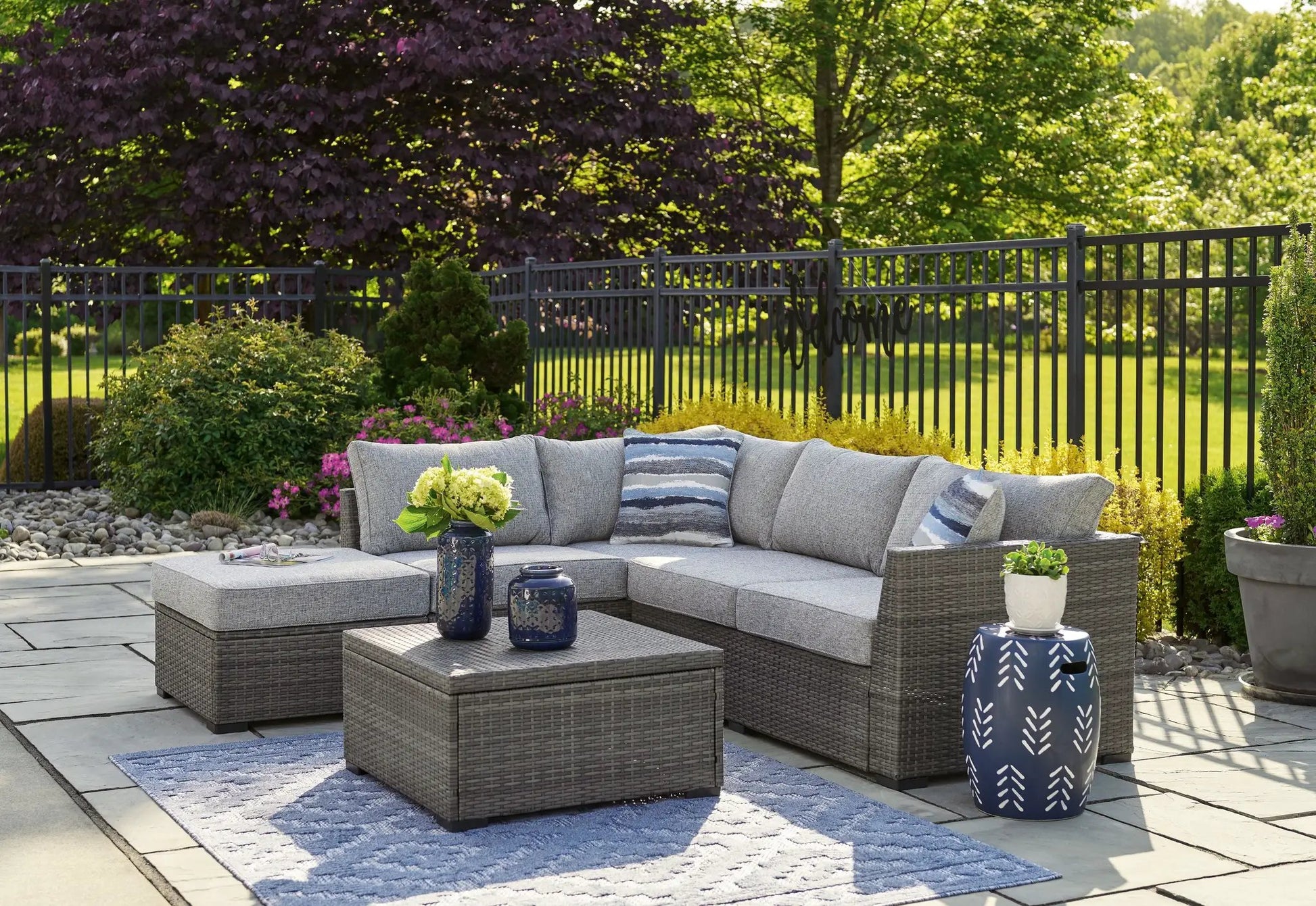 Petal Road gray outdoor wicker 4-piece set with loveseat sectional, ottoman and table on Tampa Home & Garden Store