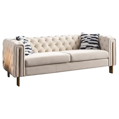 Chesterfield modern tufted sofa, beige fabric, 84.25W, brass legs, two navy pillows on Tampa Home & Garden Store