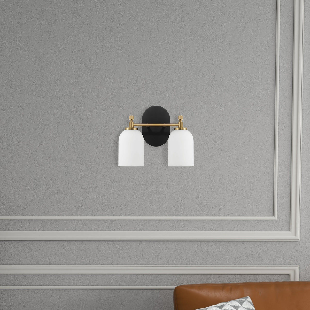 2-light vanity wall sconce with frosted glass shades in black and gold on gray wall on Tampa Home & Garden Store