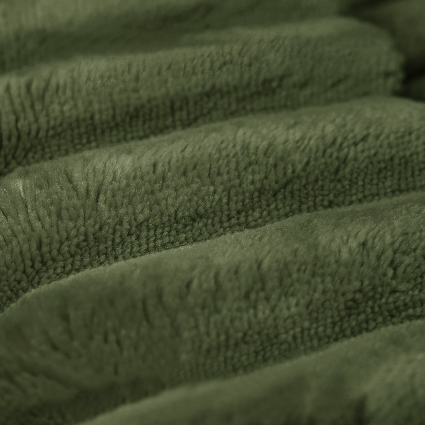 Green plush corduroy ottoman fabric close-up with textured ridges on Tampa Home & Garden Store