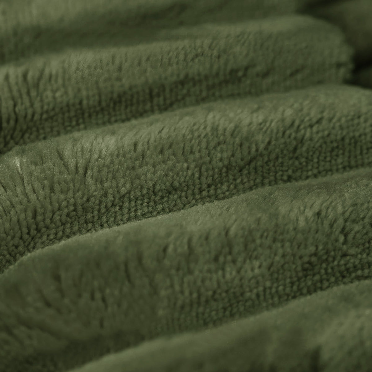 Green plush corduroy ottoman fabric close-up with textured ridges on Tampa Home & Garden Store
