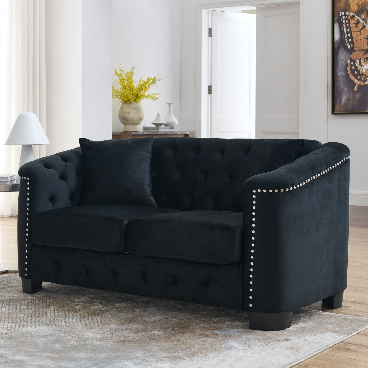 Modern Chesterfield sofa with tufted backrest in black velvet, nailhead trim along arms on Tampa Home & Garden Store