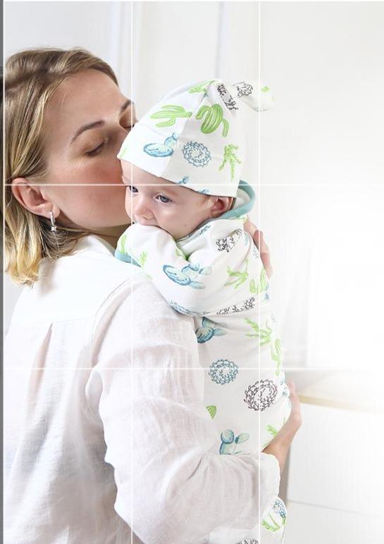 Baby swaddle blanket with cap by Stevvex, white fabric with blue-green sea creature print on Tampa Home & Garden Store
