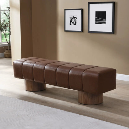 Upholstered dining bench in brown leather with tufted sections and wooden legs on Tampa Home & Garden Store